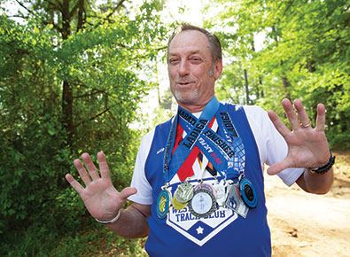 man with a lot of medals around his neck